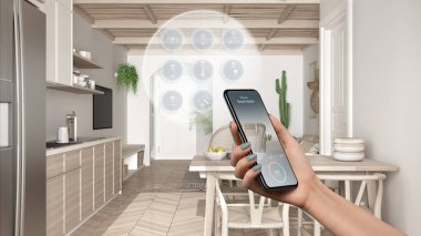 Telefon uygulamasında akıllı ev teknolojisi arayüzü, artırılmış gerçeklik, şeylerin interneti, yemek masalı modern mutfağın iç tasarımı, kadın el kumandası cihazı.
