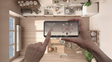 Dijital akıllı telefon tabletindeki uzaktan kumanda sistemi. Uygulama simgeleri olan aygıt. Arka planda masa, mimari tasarım, üst görünüm, plan, yukarıdaki kır mutfağı.