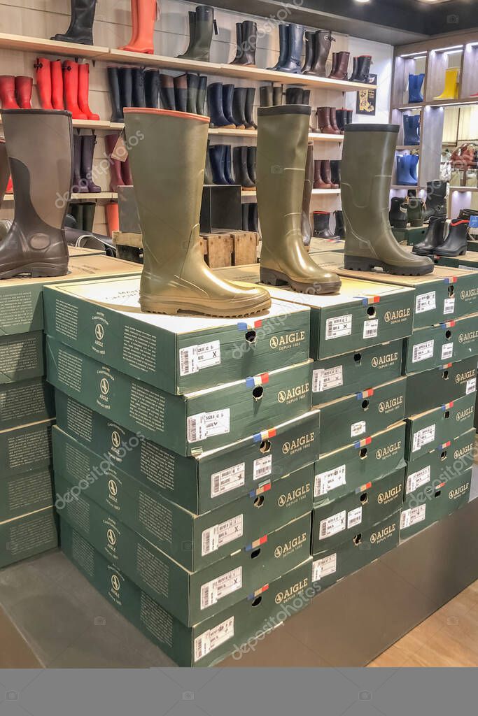 INGRANDES, FRANCE - AUGUST 26, 2020: Well-known French brand AIGLE rubber boots in the store. Factory Store.