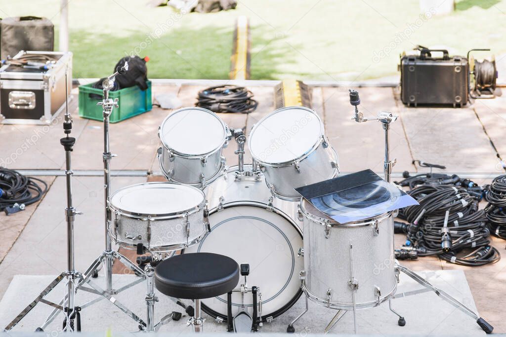 White drums and cymbals on a stage