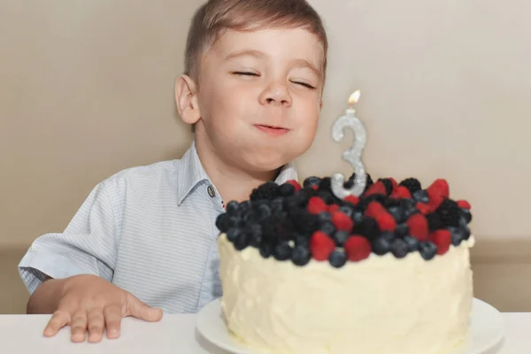 Boy blows out the candles for his birthday — Stock Photo, Image