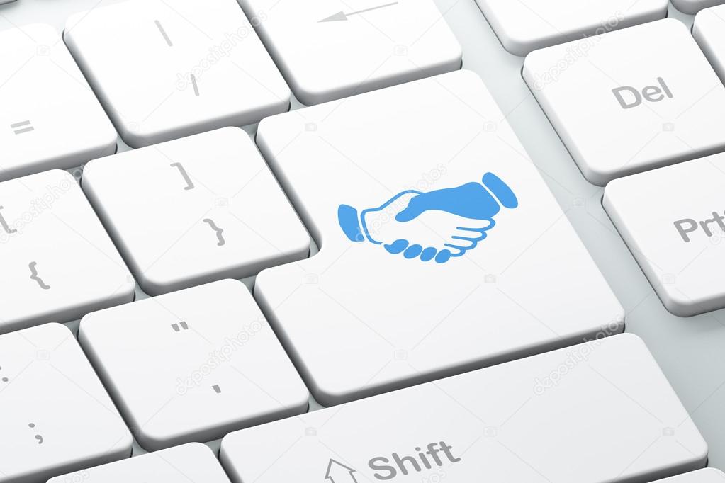 Business concept: Handshake on computer keyboard background