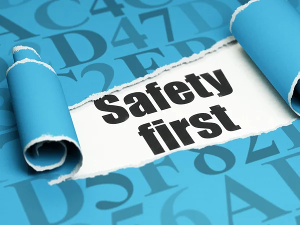 Safety concept: black text Safety First under the piece of  torn paper — Stock Photo, Image