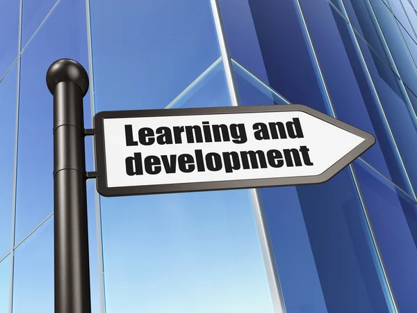 Education concept: sign Learning And Development on Building background — 图库照片
