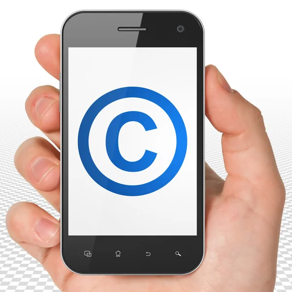 Law concept: Hand Holding Smartphone with Copyright on display — Stock Photo, Image