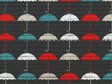 Protection concept: Umbrella icons on wall background