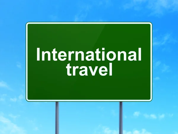 Conceito de turismo: International Travel on road sign background — Fotografia de Stock