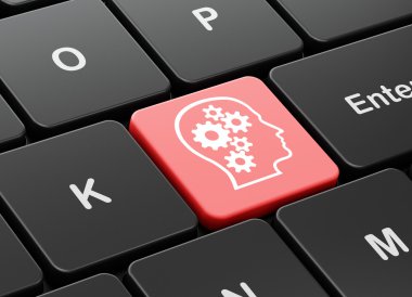 Studying concept: Head With Gears on computer keyboard background