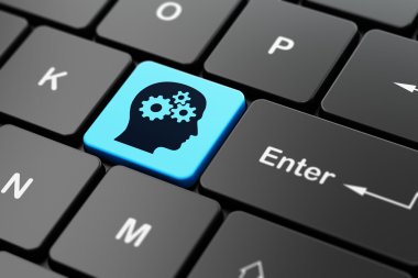 Studying concept: Head With Gears on computer keyboard background