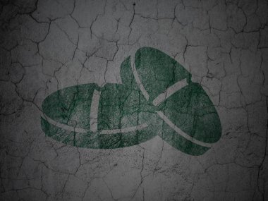 Medicine concept: Pills on grunge wall background