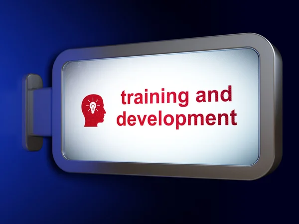 Learning concept: Training and Development and Head With Light Bulb on billboard background — Stock Photo, Image