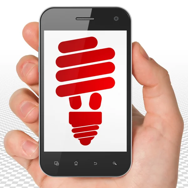Business concept: Hand Holding Smartphone with Energy Saving Lamp on display — Φωτογραφία Αρχείου