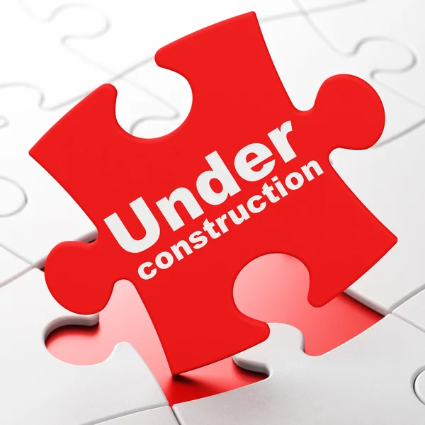 Concept de conception Web : En construction sur fond de puzzle — Photo