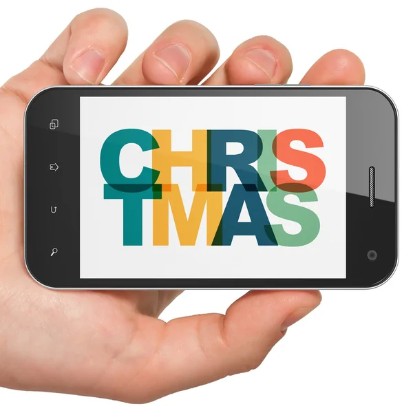 Vakantie concept: hand holding smartphone met kerst op display — Stockfoto