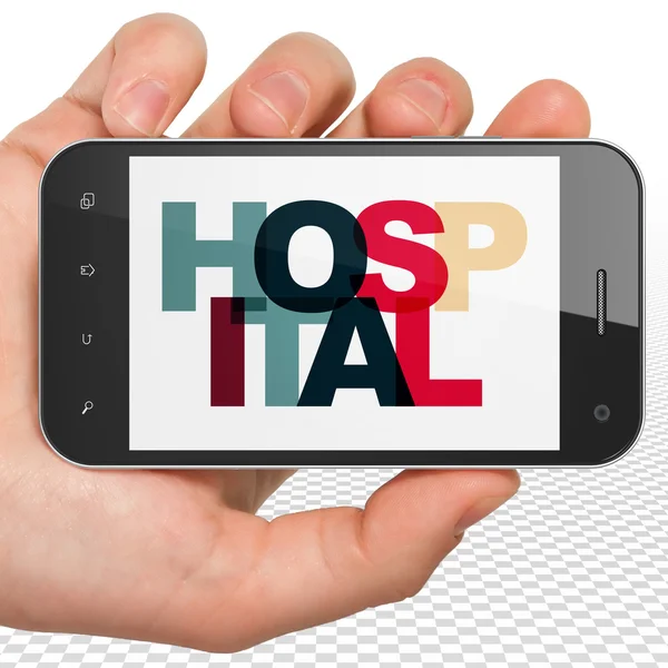 Conceito de cuidados de saúde: mão segurando Smartphone com hospital em exposição — Fotografia de Stock