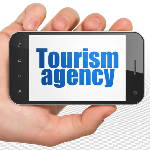 Concepto de vacaciones: Smartphone de mano con Agencia de Turismo en exhibición — Foto de Stock