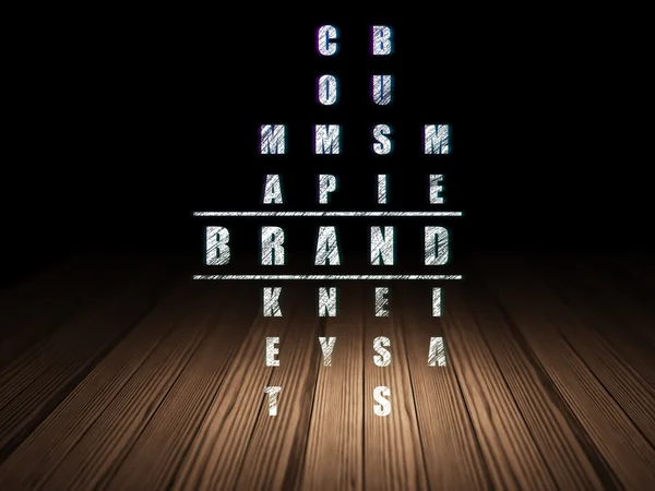 Advertising concept: word Brand in solving Crossword Puzzle
