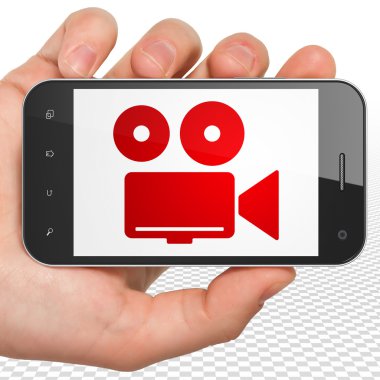 Tourism concept: Hand Holding Smartphone with Camera on display