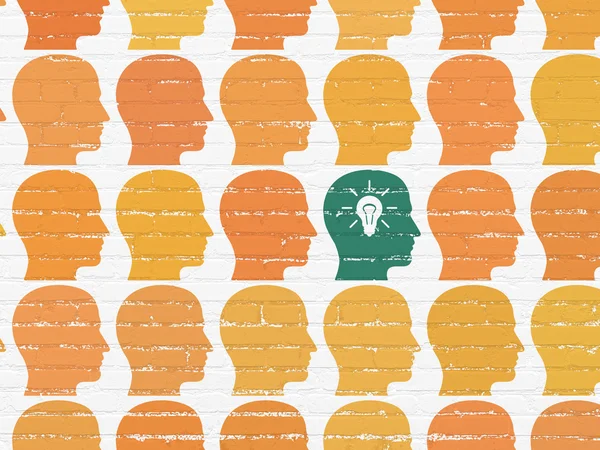 Finance concept: head with light bulb icon on wall background — Stock Photo, Image