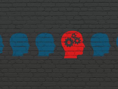 Education concept: head with gears icon on wall background