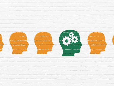 Learning concept: head with gears icon on wall background