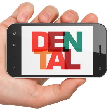 Medicine concept: Hand Holding Smartphone with Dental on  display