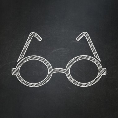 Studying concept: Glasses on chalkboard background