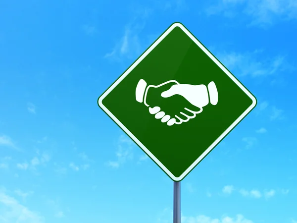 Finance concept: Handshake on road sign background — Stock Photo, Image