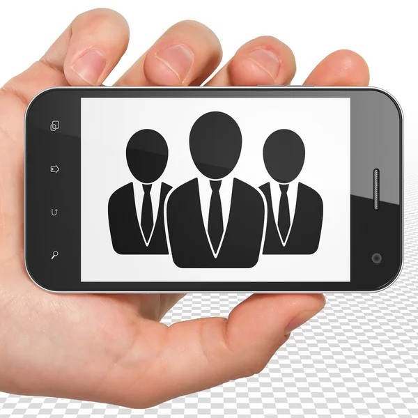 Business concept: Hand Holding Smartphone with Business People on display — Stock Photo, Image