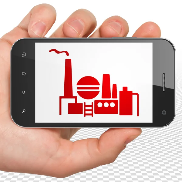 Business concept: Hand Holding Smartphone with Oil And Gas Indusry on display — Stock Fotó