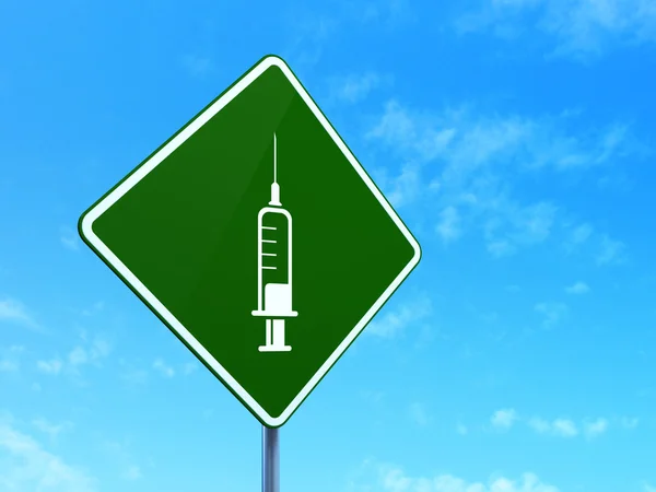 Medicine concept: Syringe on road sign background — ストック写真