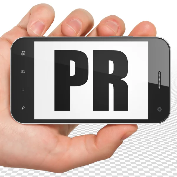 Маркетинговая концепция: ручной смартфон с PR на экране — стоковое фото