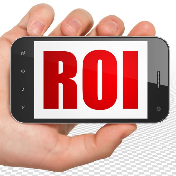 Finance concept: Hand Holding Smartphone with ROI on display — Stockfoto