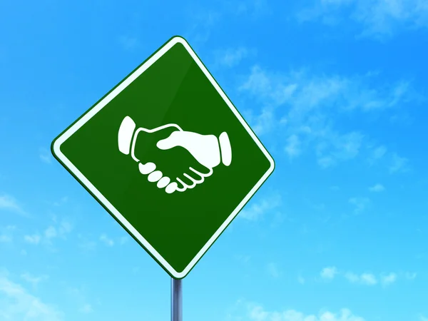 Finance concept: Handshake on road sign background — Stock Photo, Image