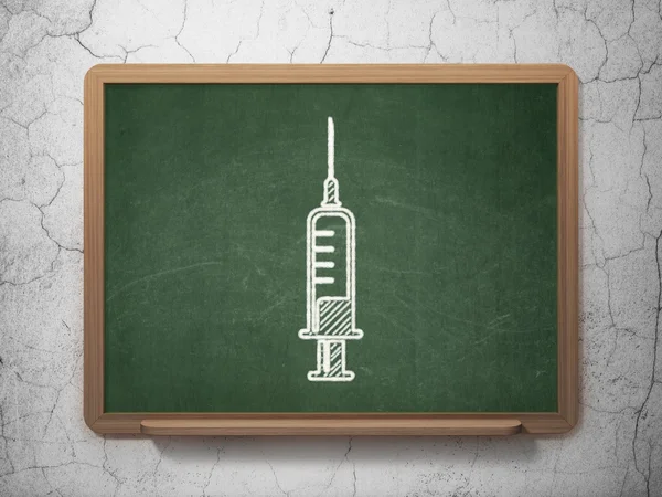 Healthcare concept: Syringe on chalkboard background — Stock Fotó