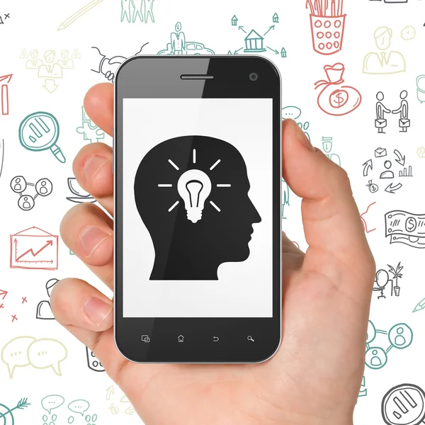 Business concept: Hand Holding Smartphone with Head With Light Bulb on display — Stockfoto