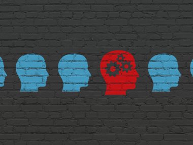 Business concept: head with gears icon on wall background