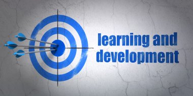 Studying concept: target and Learning And Development on wall background