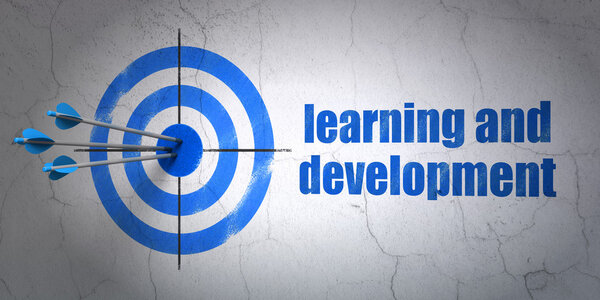 Studying concept: target and Learning And Development on wall background