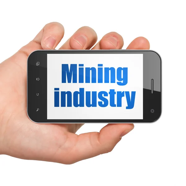 Concepto de industria: Smartphone de mano con industria minera en exhibición —  Fotos de Stock