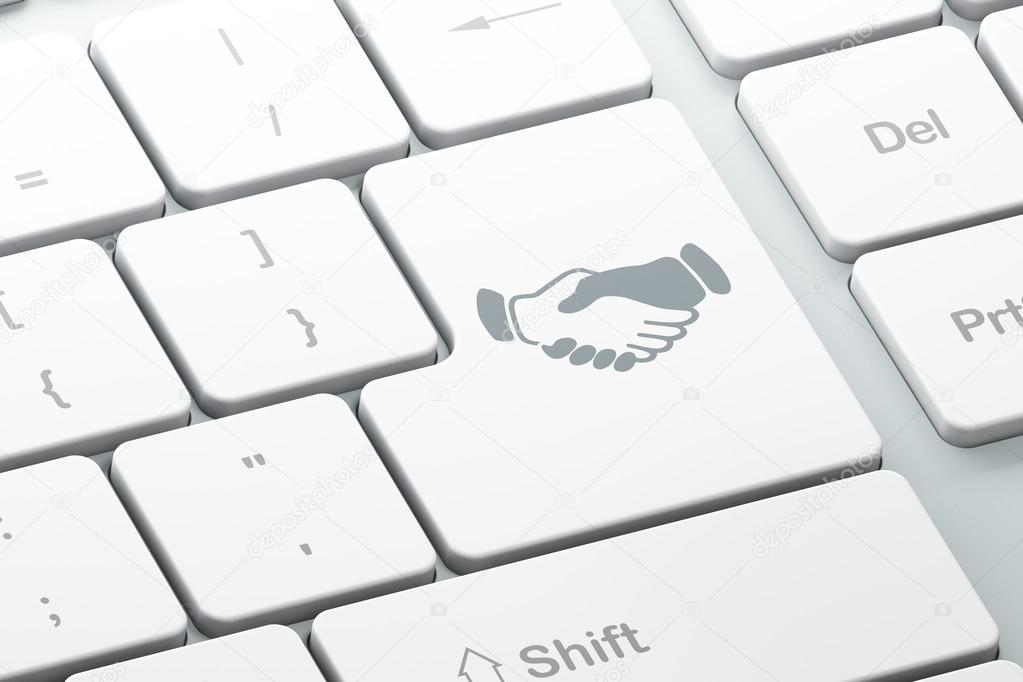 Business concept: Handshake on computer keyboard background