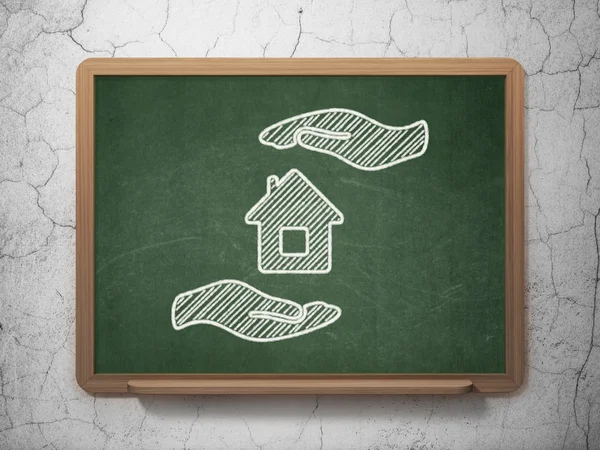 Insurance concept: House And Palm on chalkboard background — Stok fotoğraf