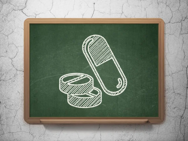 Medicine concept: Pills on chalkboard background — Stock Photo, Image