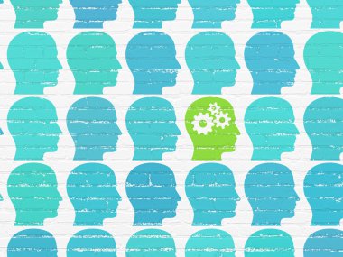 Learning concept: head with gears icon on wall background