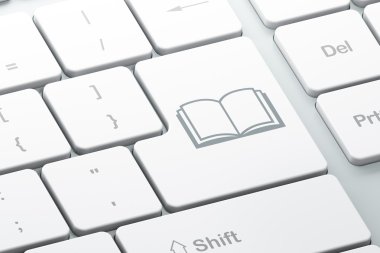 Kavram öğrenme: bilgisayar klavye arka plan üzerinde kitap