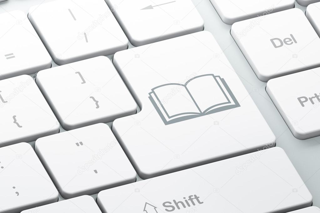 Learning concept: Book on computer keyboard background