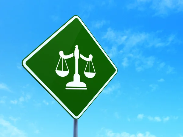 Law concept: Scales on road sign background — Stockfoto