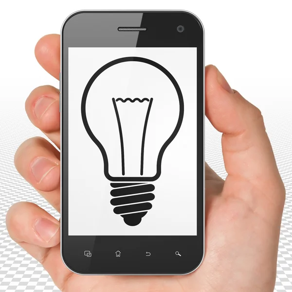 Business concept: Hand Holding Smartphone with Light Bulb on display — Stok fotoğraf