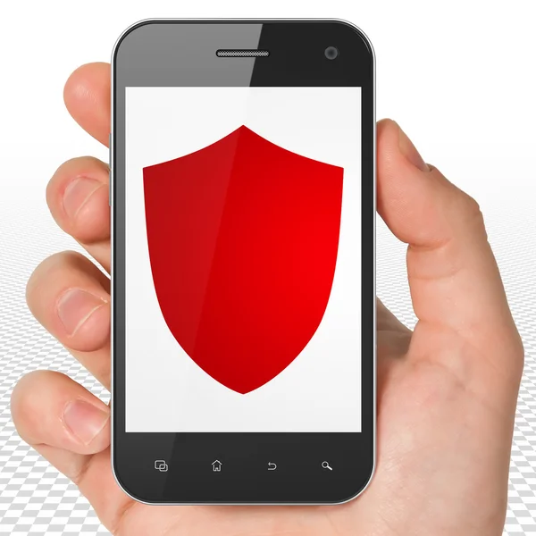 Security concept: Hand Holding Smartphone with Shield on display — Stock Photo, Image