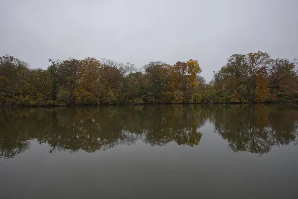 Lake view with autumn trees at Lake Roland Park Baltimore Maryland USA